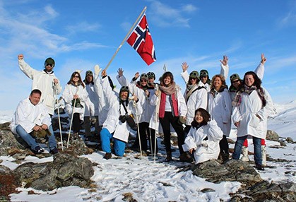 Group of tourists posing on mountain top