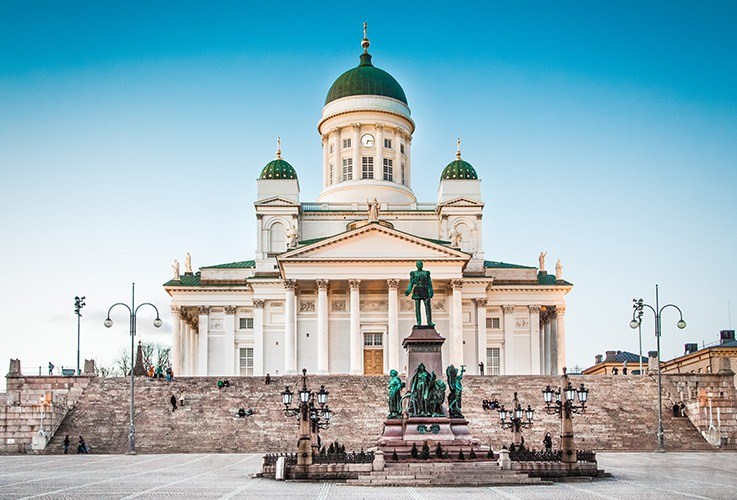 Large building with green roof and statue