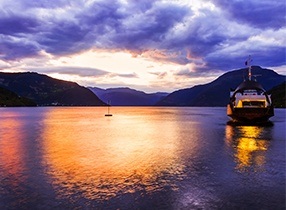 boat on water at night time on a norwegian fjord