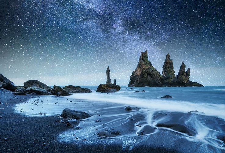 Black sand beach overlooking ocean