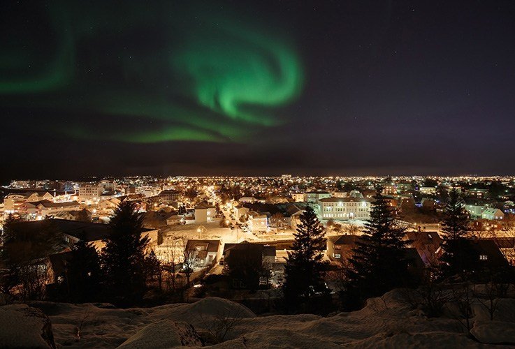 Northern lights over city