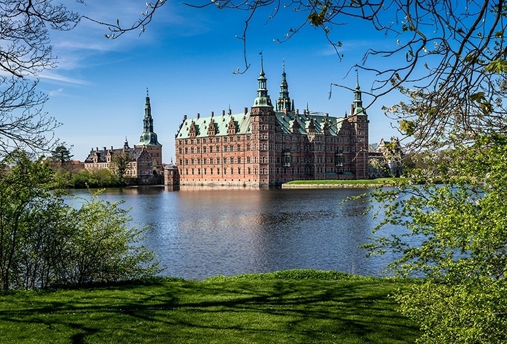 Large castle overlooking water in Denmark