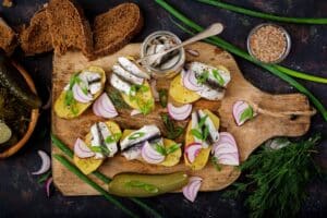 appetizer of herring anchovy and baked potato