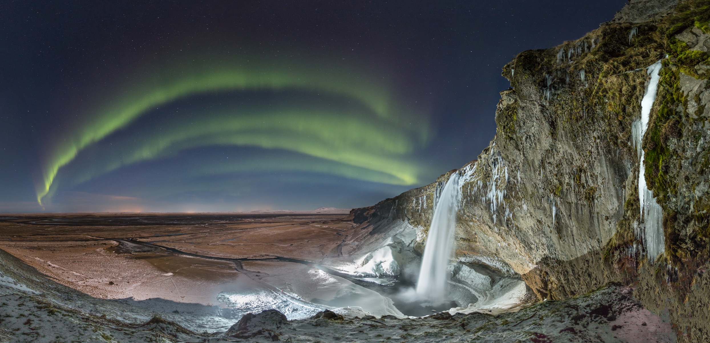 waterfall and northern lights in iceland 