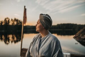 Woman on pier at sunset Visit Saimaa